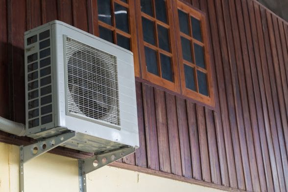 Airconditioning Unit attached in a wooden wall