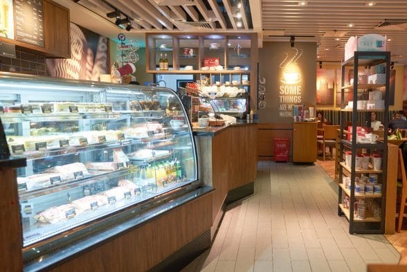 A cafe with huge cake and pastry display commercial fridge