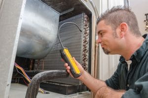 Allen Air & Refrigeration Mechanic Electrical Testing an Airconditioning Unit